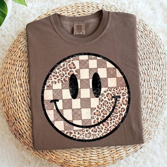 Brown sweatshirt with a smiley face design on a woven surface