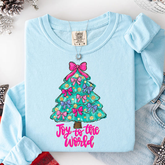 Light blue long sleeve shirt with a Christmas tree design and 'Joy to the World' text on a white surface.