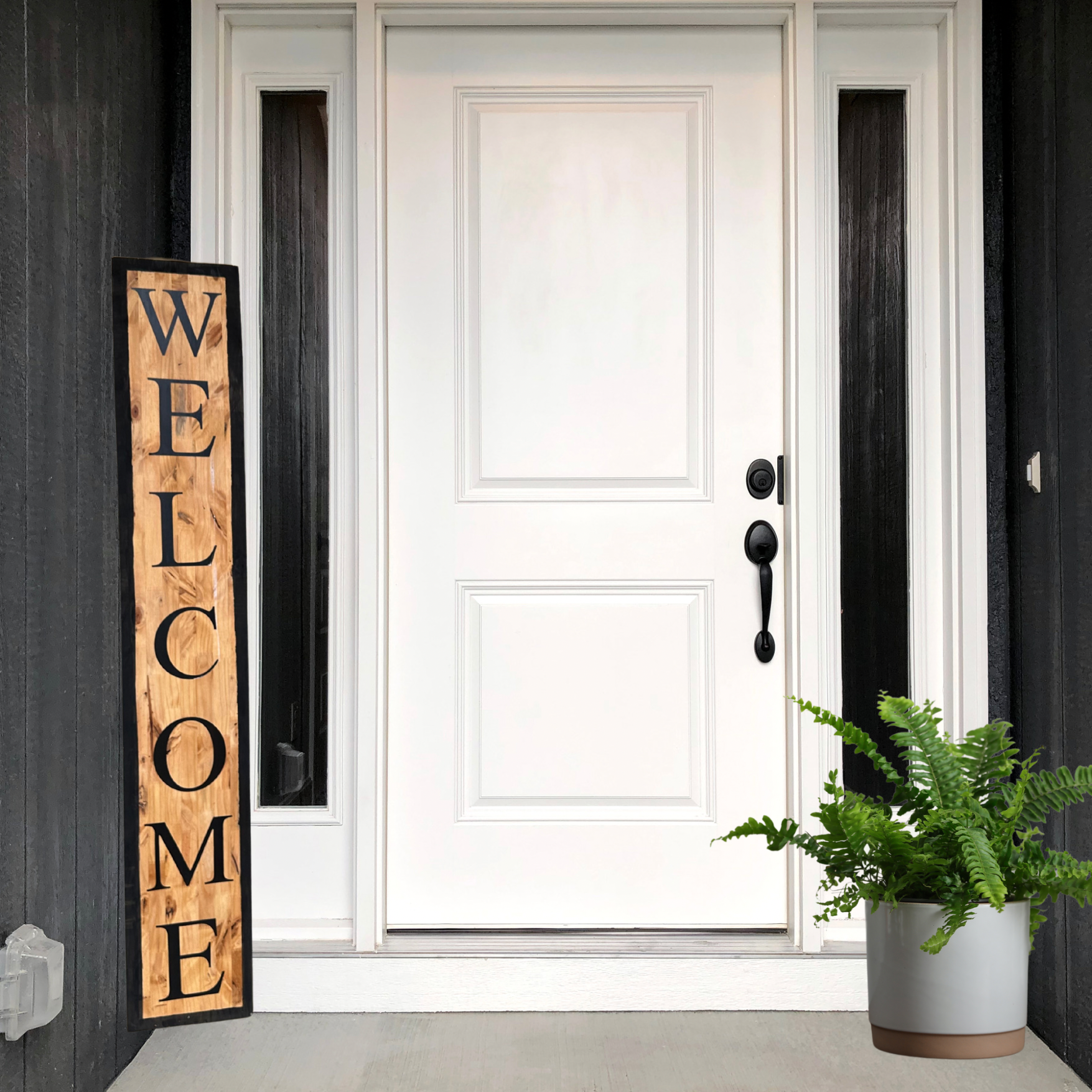 White front door with wood welcome sign and outdoor fern for decoration, showcasing sign styling.
