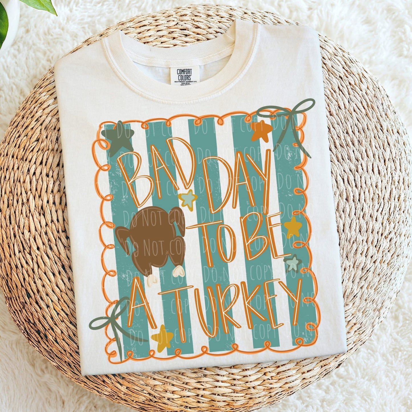 White shirt with 'Bad Day to be a Turkey' design on a woven mat