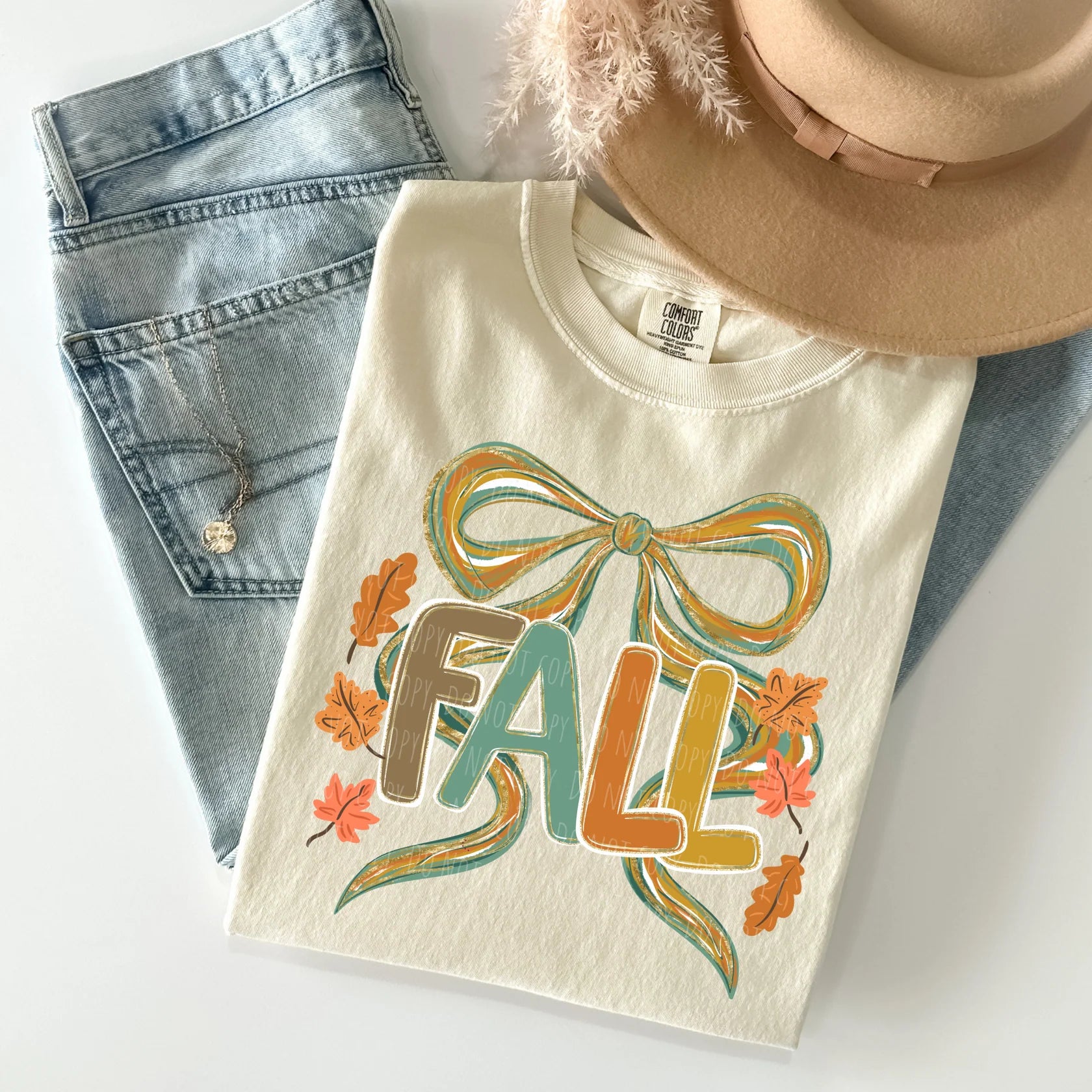 Beige t-shirt with 'Fall' design, denim shorts, and a beige hat on a white background
