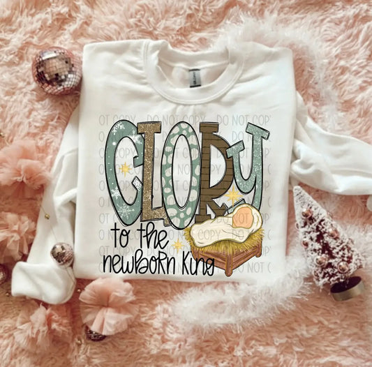 White sweatshirt with 'GLORY to the newborn King' text on a pink fluffy background