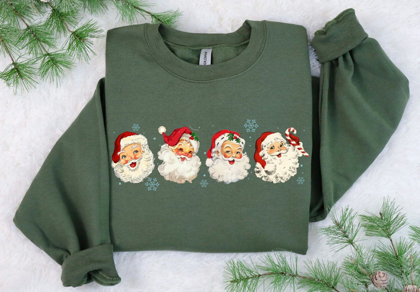 Green sweatshirt with Christmas-themed designs on a snowy background